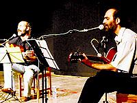 Acar Akalin and Ahmet Okan performing together at a concert